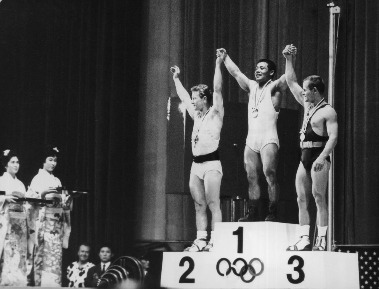 The three winners of the featherweight weightlifting event on October 14, 1964. From left to right, they are Isaac Berger of the U.S. (silver), Yoshinobu Miyake of Japan (gold) and Mieczyslaw Nowak of Poland (bronze). 