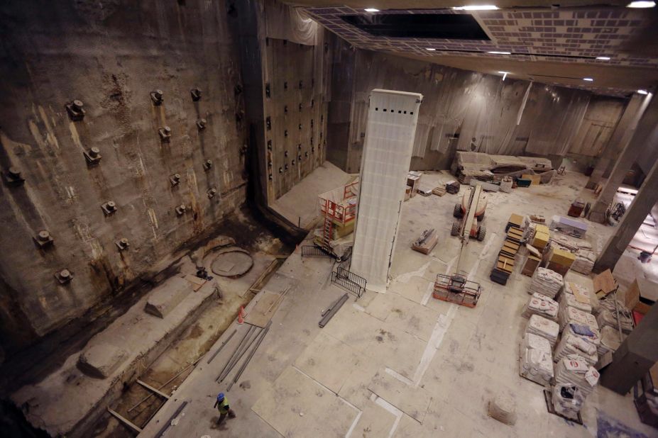 Part of the World Trade Center's original foundation, left, and the last column removed from the WTC site, center, are covered in a protective wrap during construction of the museum.