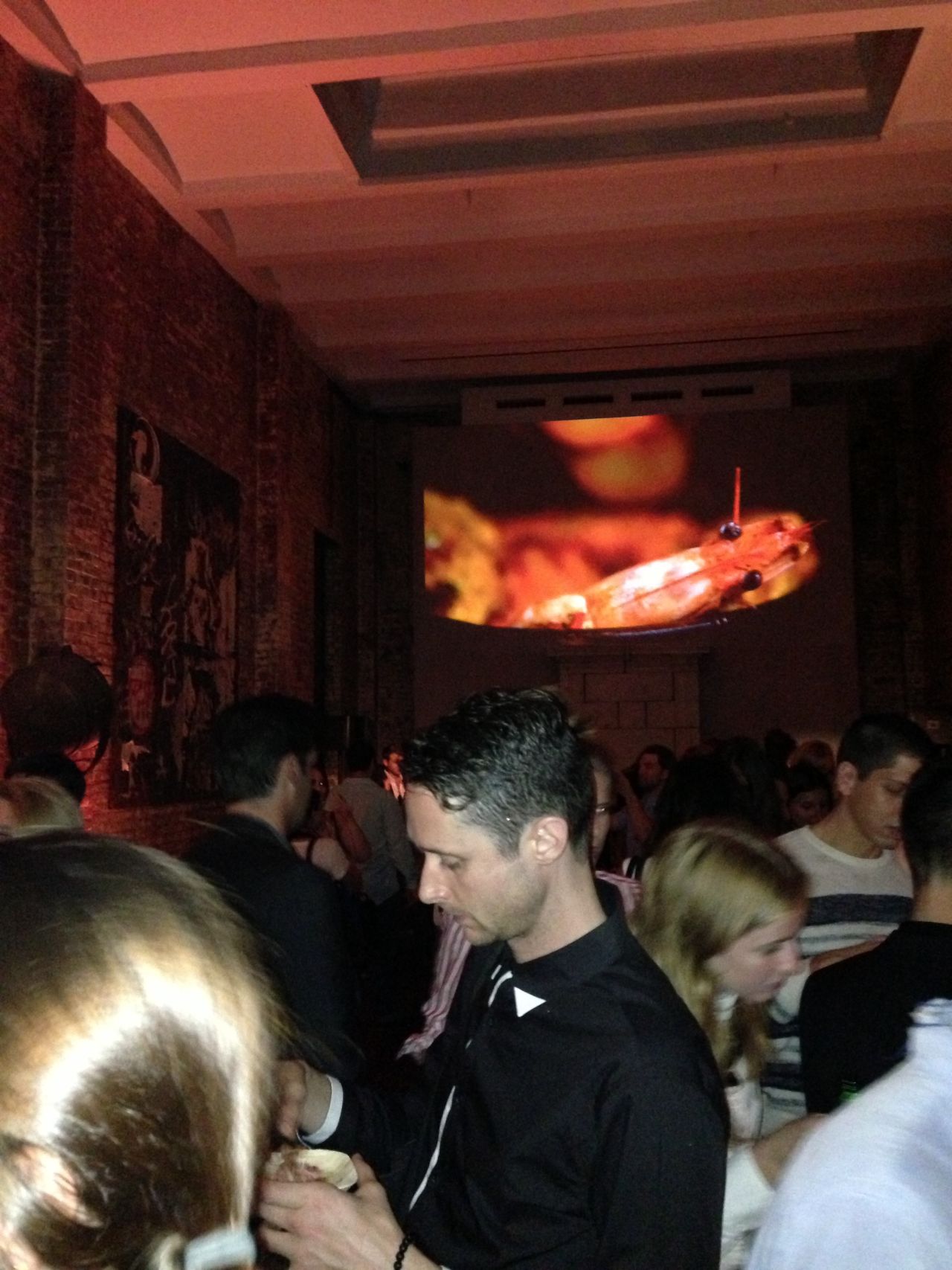 Upstairs guests feast in front of giant food on the back wall, including the prawn pictured here. 