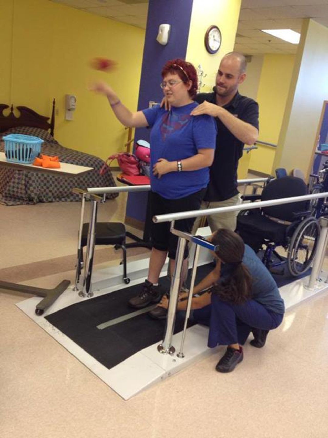 Emily throws bean bags while standing at a therapy session on September 3, a week after she returned to school.