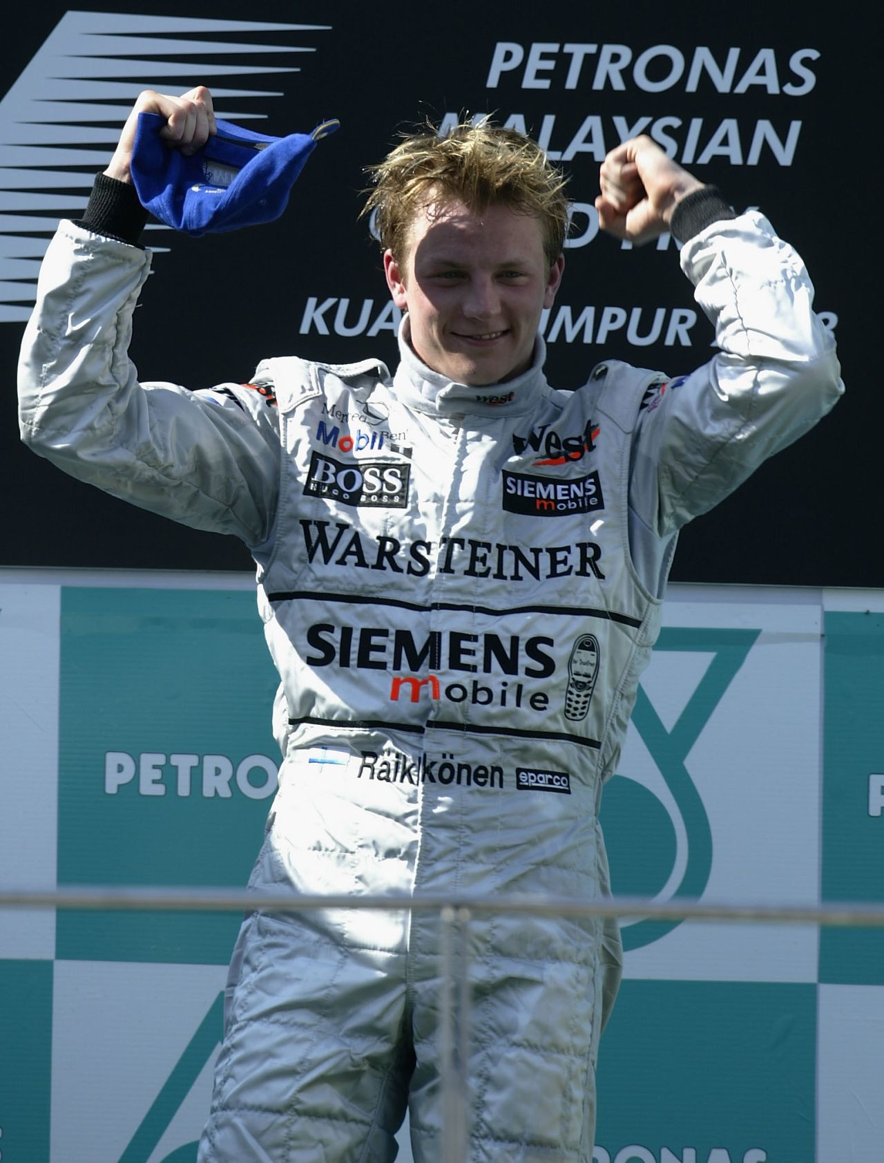Raikkonen celebrates his maiden grand prix win in Malaysia in 2003. He had moved to McLaren, where he would spend five years, twice finishing as runner-up in the drivers' championship.