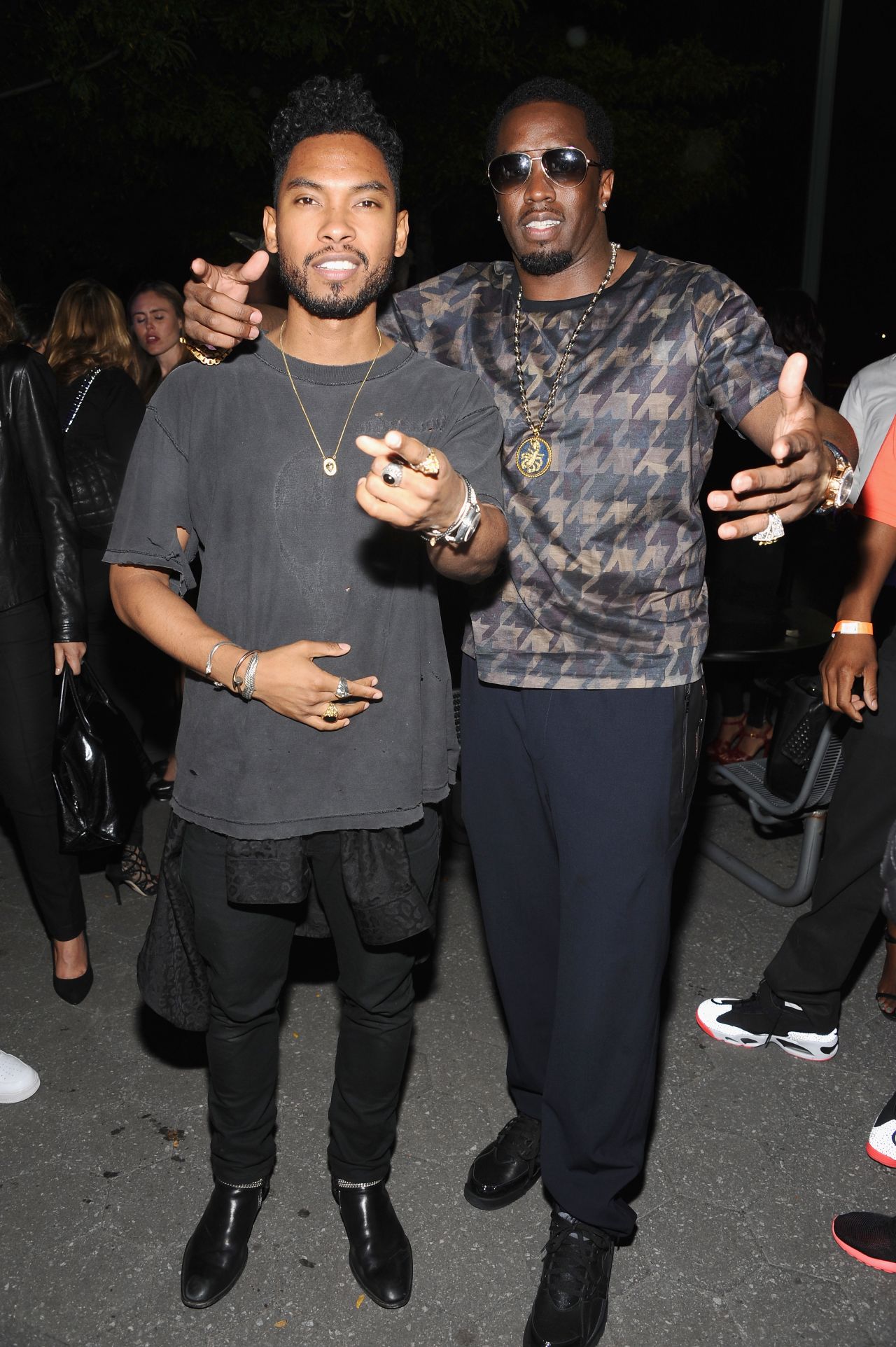 Miguel and P. Diddy have a bonding moment at Janelle Monae's release party on September 9. 