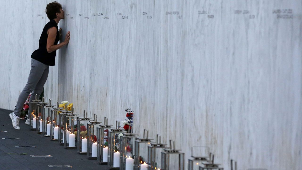 A woman kisses one of the 40 names on the Flight 93 National Memorial wall in Shanksville, Pennsylvania, on September 10. United Airlines Flight 93 crashed into a field near Shanksville on 9/11.