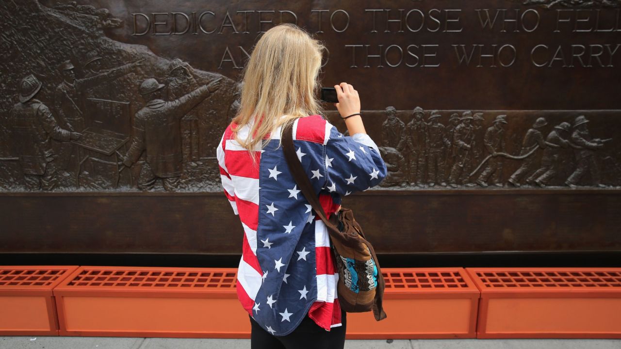 A woman takes photos of the 9/11 Memorial in New York on September 10.