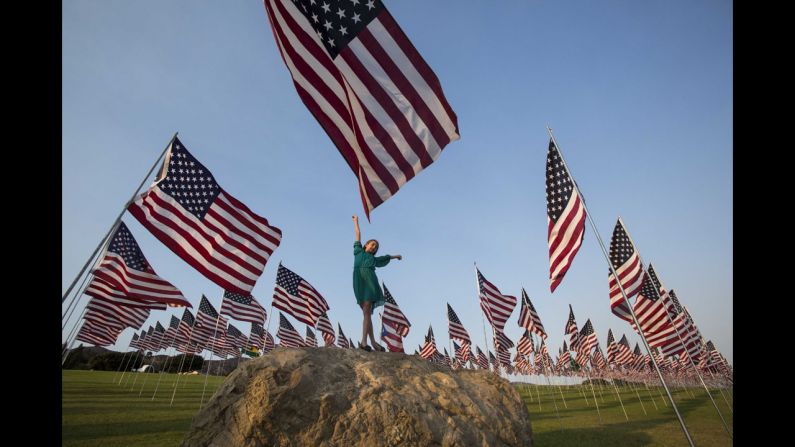 A girl poses among American flags that Pepperdine University students and staff erected in Malibu, California, on September 10.