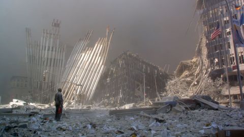 A man stands in the rubble after the collapse of the first World Trade Center tower.