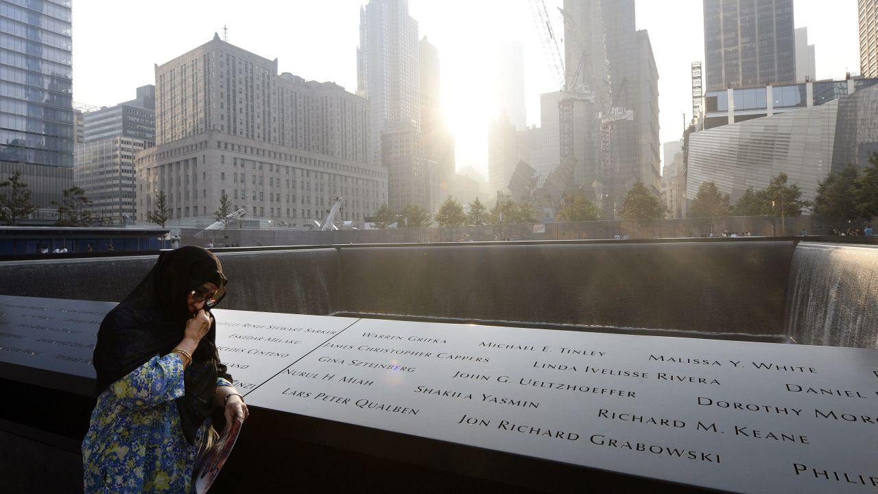 Showkatara Sharif stands next to the engraving of her daughter's name, Shakila Yasmin, at the edge of the north pool at the 9/11 Memorial in New York on September 11.