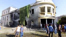 People gather to look at the site of a car bombing in Benghazi, Libya, on Wednesday, September 11.