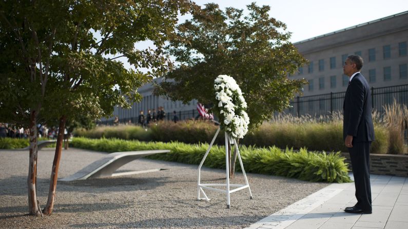 President Barack Obama listens to military taps after laying a wreath at the Pentagon in Arlington, Virginia, on September 11.