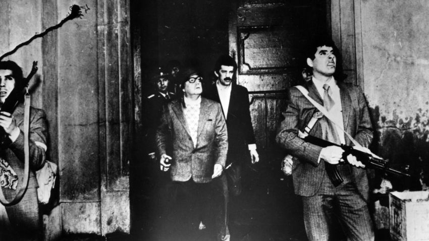 Armed guards watch out for attackers as Chilean president Salvador Allende leaves the Moneda Presidential Palace during the military coup in which he was overthrown and killed.