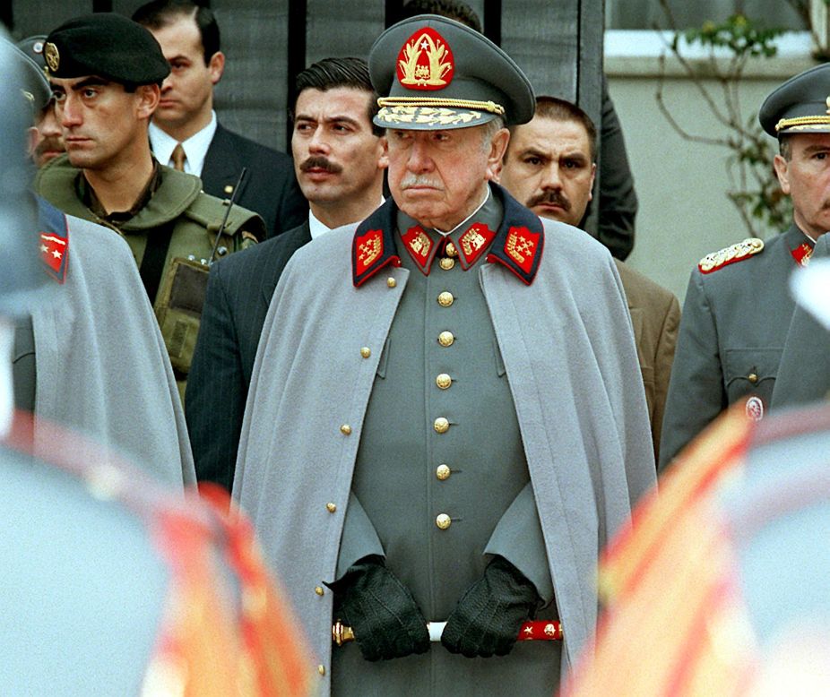 Pinochet listens to a military band playing before his residence in Santiago on September 11, 1997 to commemorate the 24th anniversary of the coup.