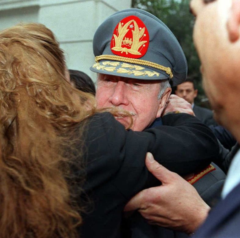Pinochet is greeted by a supporter on August 23, 1995 after leaving his house in Santiago to celebrate his 22nd anniversary as commander with military ceremonies. 