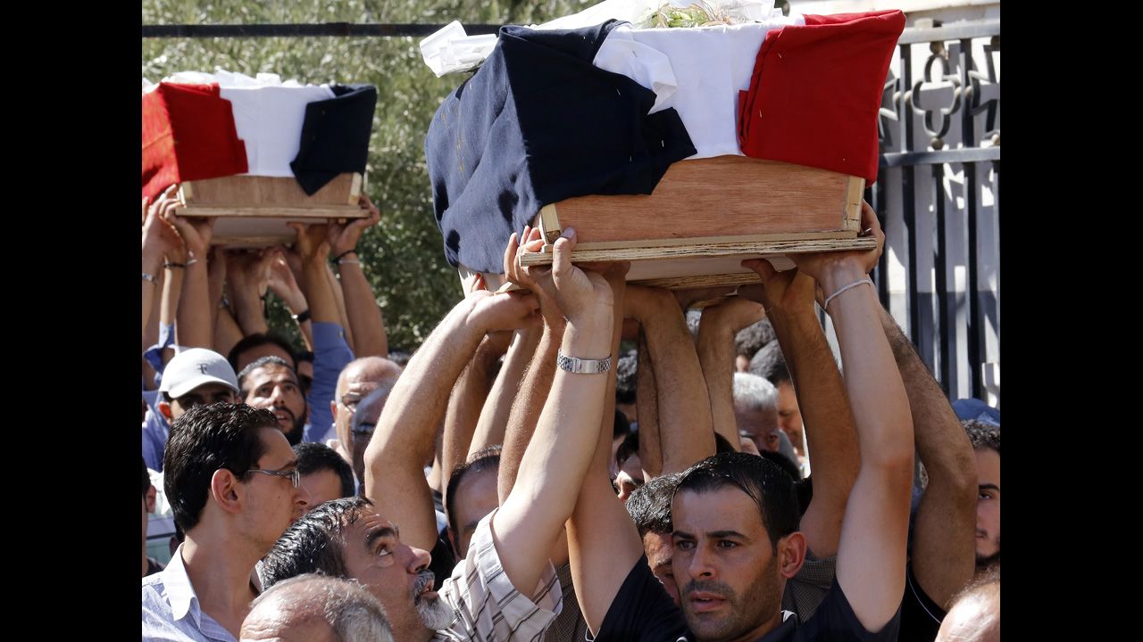 A funeral is held on September 11 for three Christian Syrians killed during battles with an al Qaeda-linked rebel group that took control of the historic Christian town of Maaloula from regime forces during the weekend.