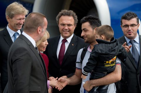 In September 2013, Lower Saxony's Commissioner for Migration and Participation Doris Schroeder-Koempf, along with German Interior Minister Hans-Peter Friedrich, center, greet the first of many Syrian refugees that have been granted temporary asylum in Germany.