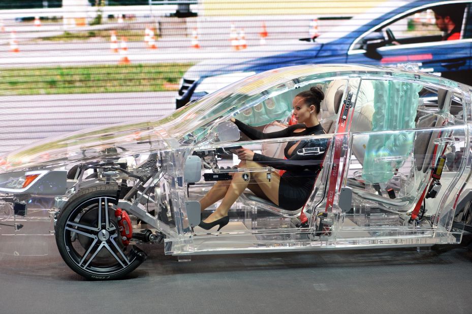 A model sits in a acrylic glass car body that shows the car technik at the IAA international automobile show on September 11, 2013 in Frankfurt, Germany. 