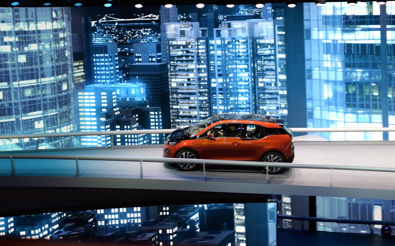Visitors test drive the first fully electric car the BMW i3 from the car maker BMW at the IAA international automobile show on September 11, 2013 in Frankfurt, Germany.