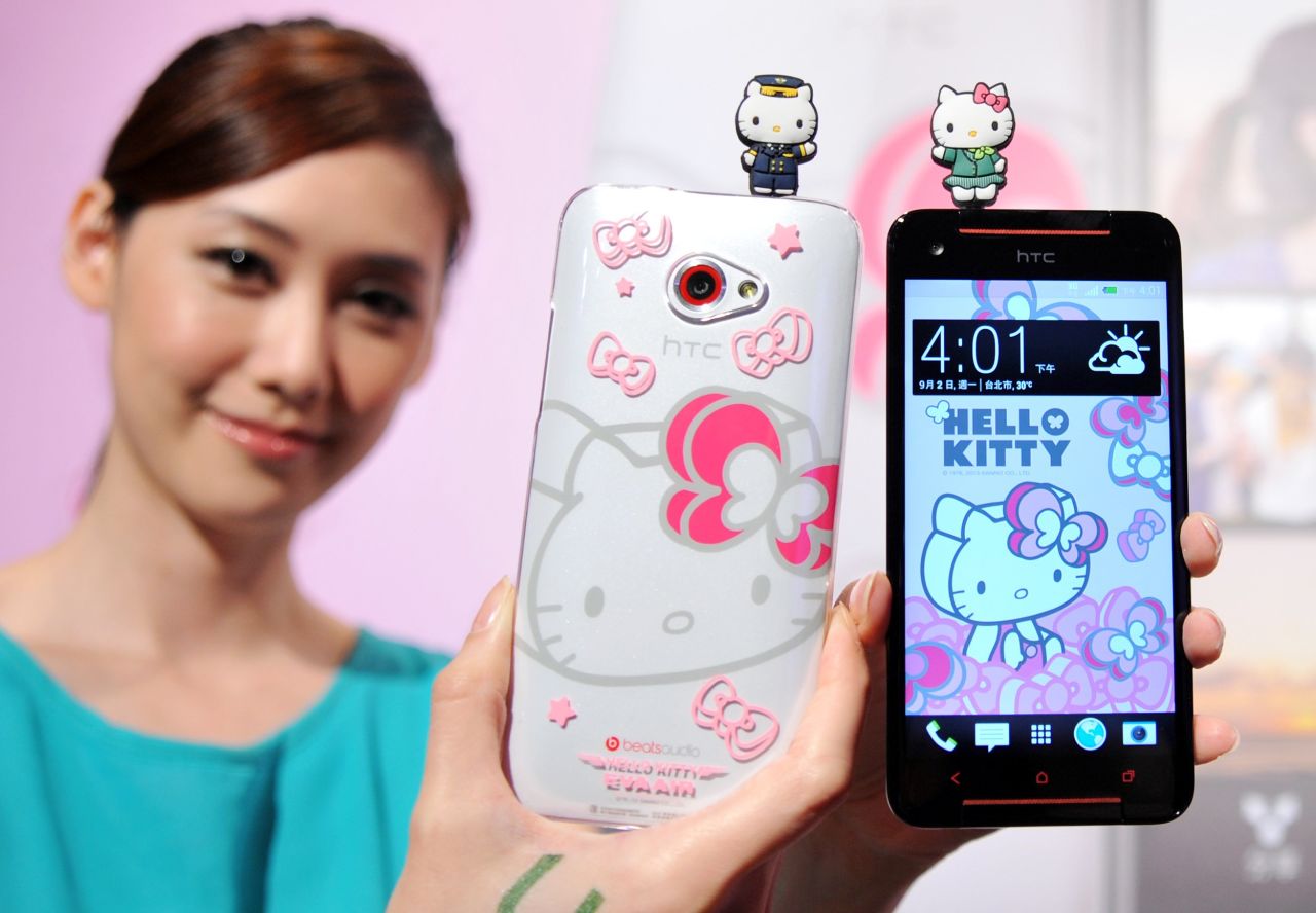 A model displays Taiwan electronics giant HTC's new smartphone "HTC Butterfly S Hello Kitty" with accessories during a press conference in Taipei on September 2, 2013. 