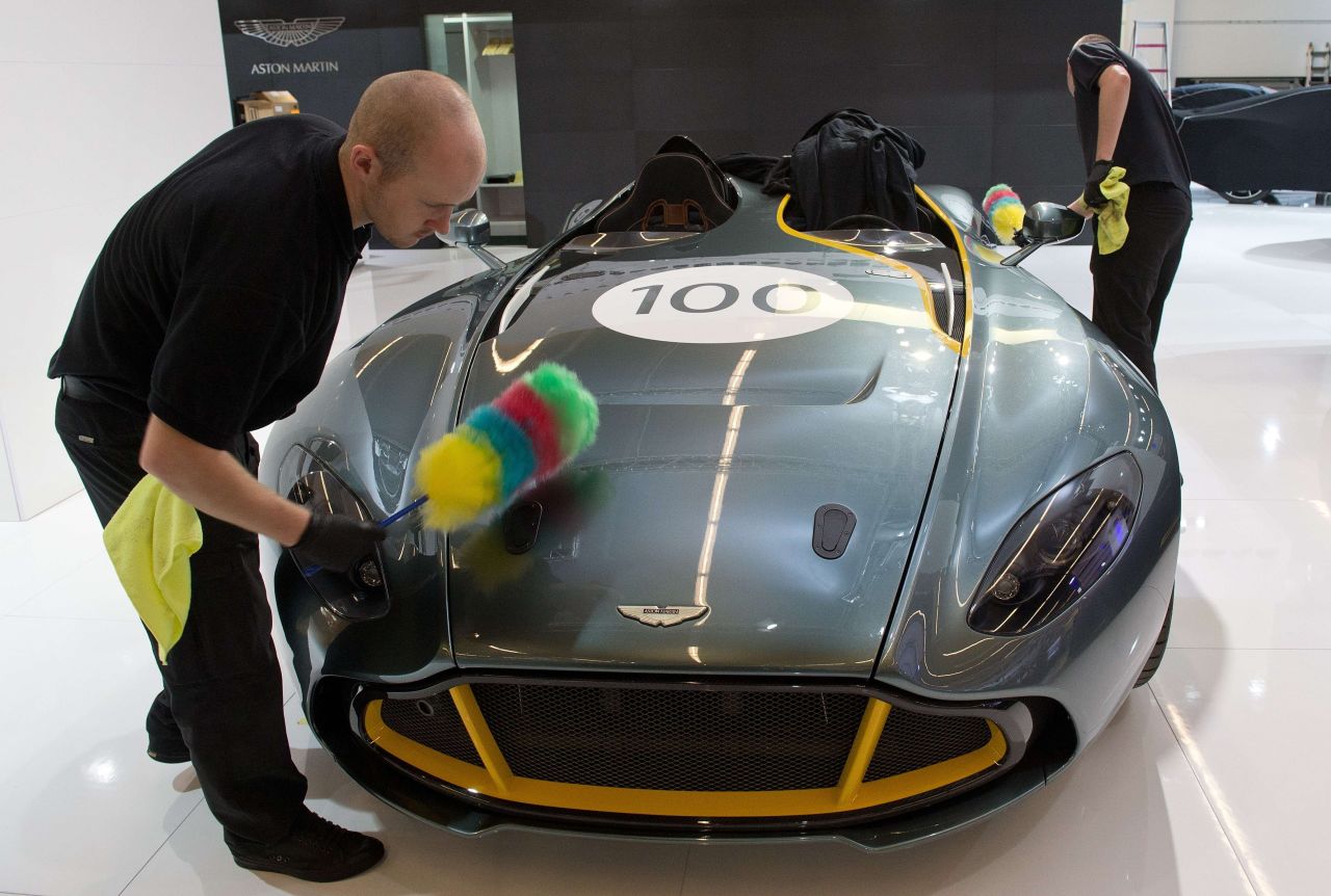 Workers clean an Aston Martin at the International Motor Show IAA in Frankfurt Main, Germany, on September 8, 2013.