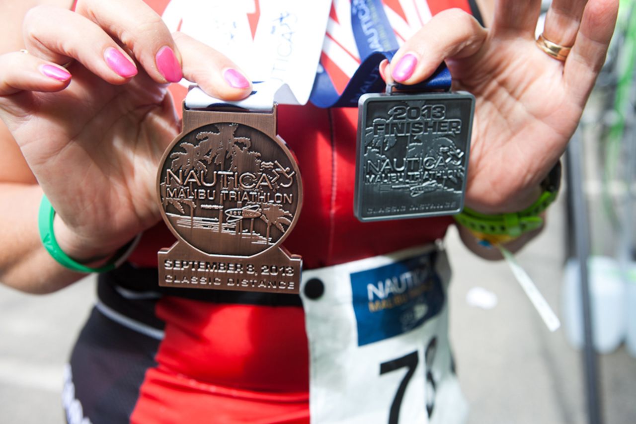 Timme shows off her two medals after finishing the triathlon. At 58, Timme is the oldest member of the Fit Nation team, and she's proven <a href="http://www.cnn.com/2013/08/16/health/fit-nation-timme-bike-commute/index.html">age is just a number</a>. "As I crossed the finish line, I remember telling myself that I had actually accomplished something that I honestly didn't think I had the physical or mental strength to do. At that moment, I felt like I could do anything!"