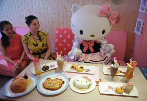 A Hello Kitty doll poses with dishes at the Hello Kitty Kitchen and Dining restaurant in Taipei on July 11, 2013. The only Taiwan Hello Kitty restaurant reopened after a month of renovations.