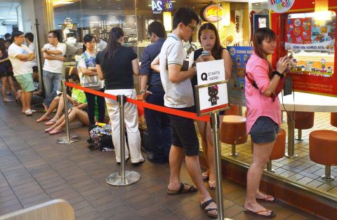 People wait in line to purchase a Hello Kitty toy in a skeleton outfit at a McDonald's restaurant in Singapore. Tempers flared and police had to be called in on June 27 as anxious Singaporeans rushed to McDonald's outlets to buy Hello Kitty plush toys being sold by the chain as a promotion. 