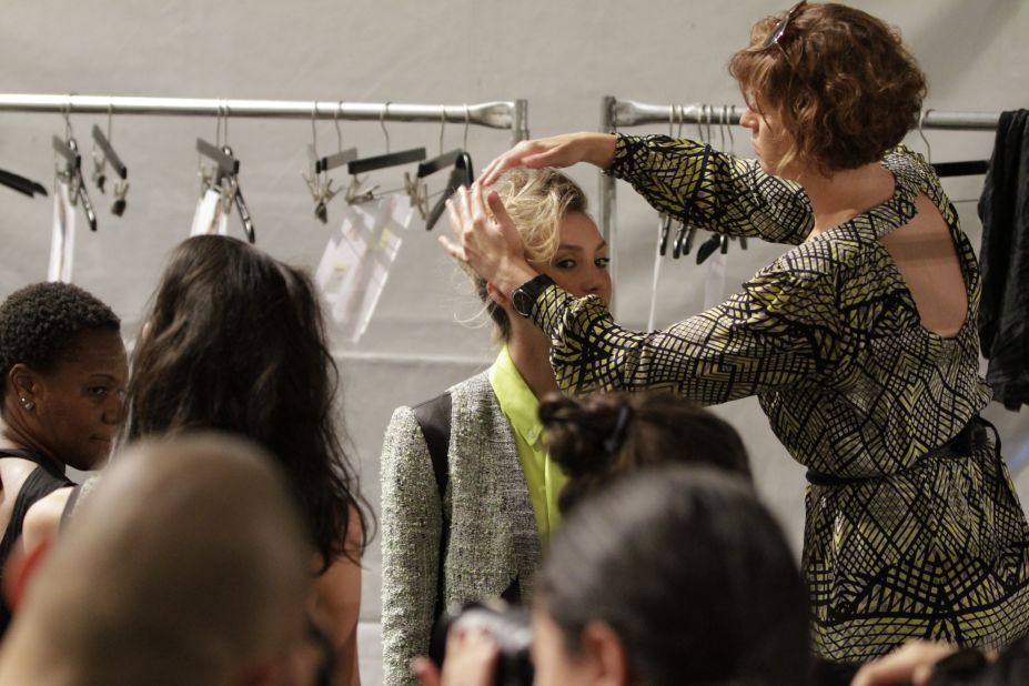 The finishing touches are put on a model's hair before she struts the catwalk for designer Marissa Webb.