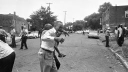 Fifty years ago a bomb exploded at the 16th Street Baptist Church in Birmingham, Alabama, killing four black children. Here a grieving relative is led away from the site of the blast after telling officers that some of his family members were in the most heavily damaged section of the church.