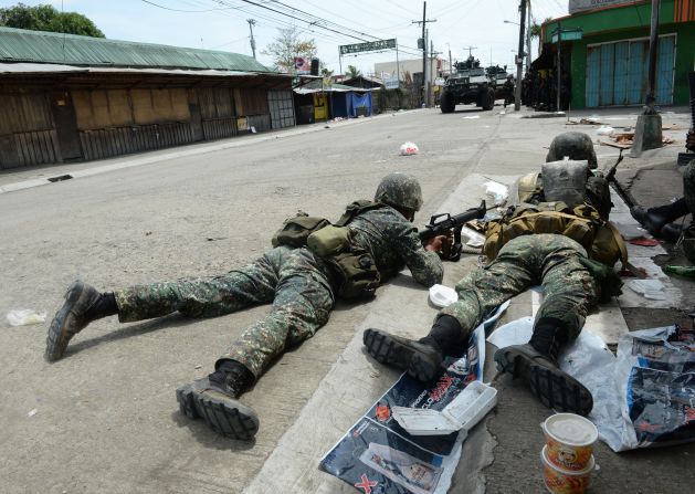 Government soldiers take cover from rebel sniper fire during heavy fighting  in Zamboanga City on September 12.