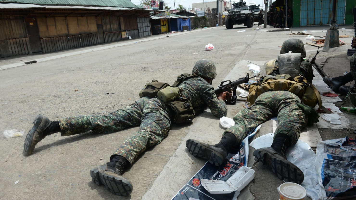 Government soldiers take cover from rebel sniper fire during heavy fighting  in Zamboanga City on September 12, 2013.