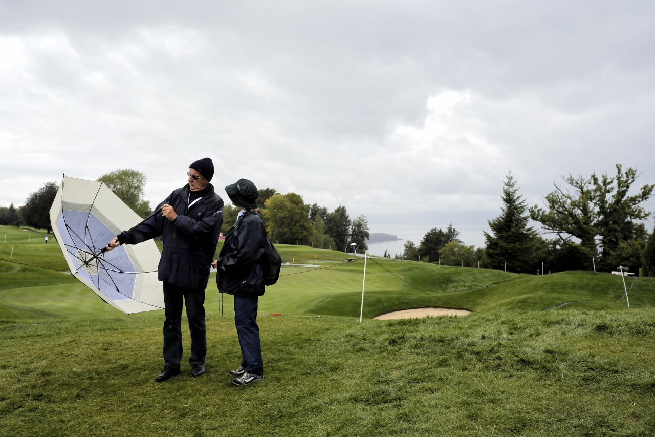Supporters wait during a rain delay in the first round of the Evian Championship women's golf tournament in Evian, France, on Thursday, September 12.