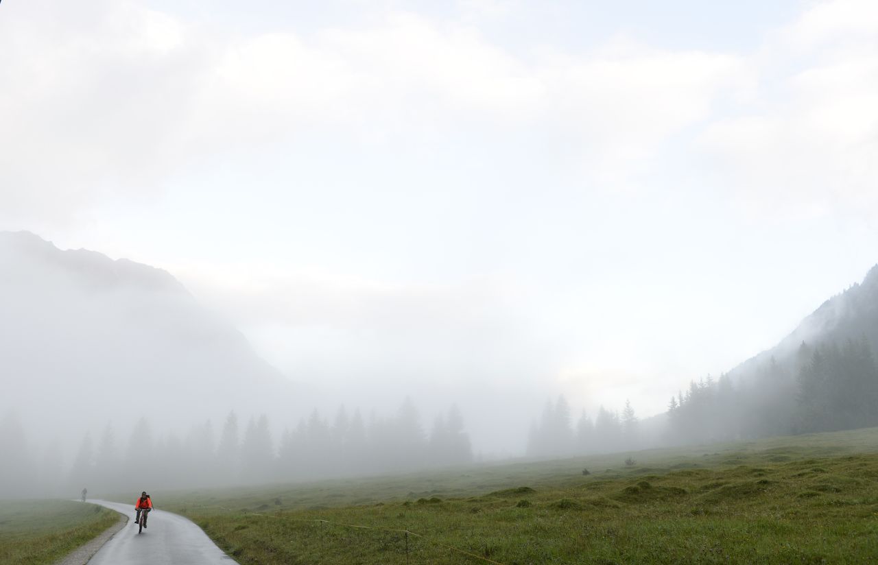 A cyclist rides in the foggy autumn weather downhill from the Alps on September 11 near the village of Bad Hindelang, Germany.
