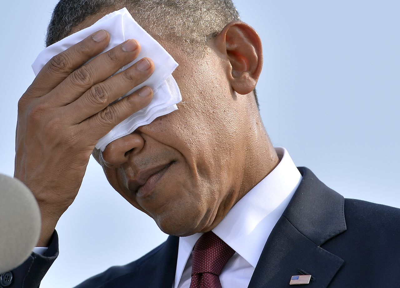 President Barack Obama wipes his forehead as he speaks during a ceremony at the Pentagon Memorial in Washington to mark the 12th anniversary of the 9/11 attacks on September 11.