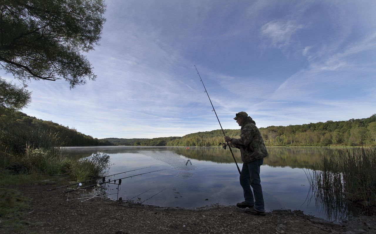 A man fishes for carp in Lackawanna State Park in Pennsylvania on Monday, September 9. Cool morning temperatures were giving way with summery weather early in the week. 