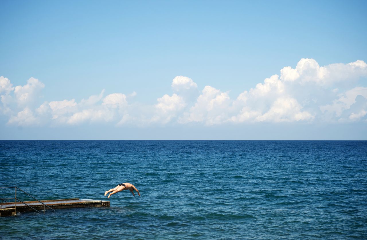 A swimmer in Izola, Slovenia, jumps into the Adriatic Sea on September 9.