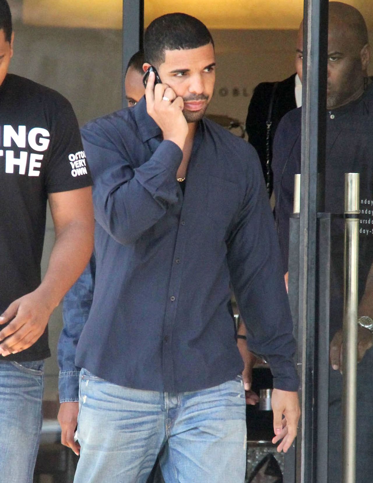 Drake chats away on the phone as he shops at Barneys on September 11.