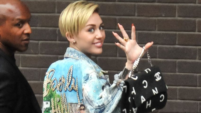 Miley Cyrus waves to fans in London on September 11.