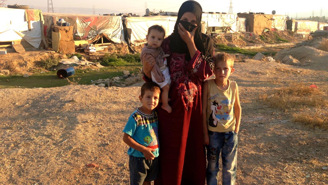 Abdel, right, his mother and two younger brothers share a 10-by-10 tent at the camp.
