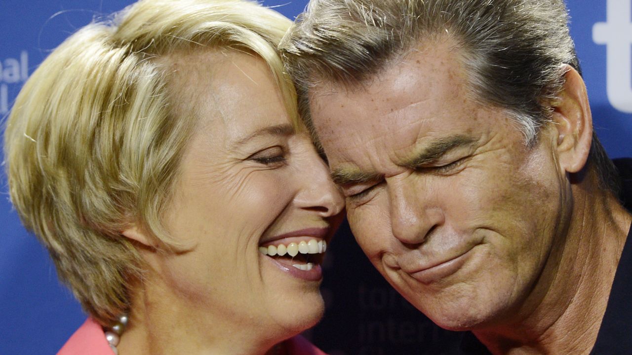Emma Thompson and Pierce Brosnan share a moment before the press conference September 12.