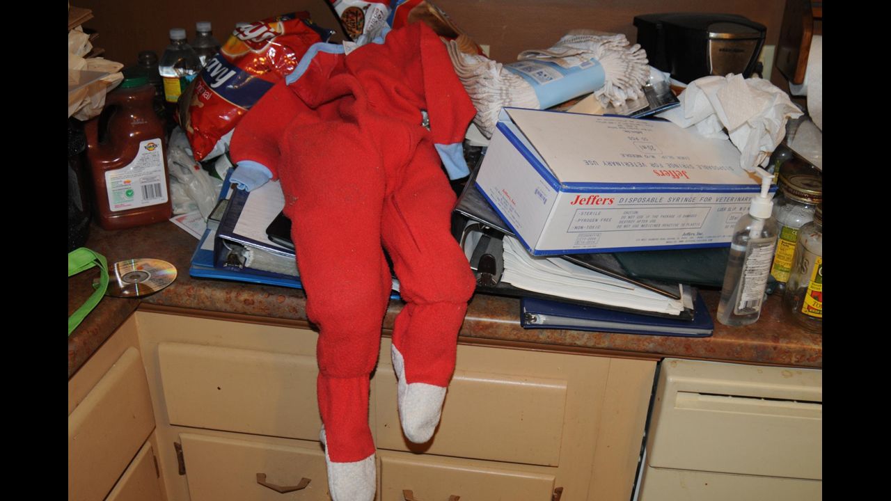 A child's orange onesie sits on the counter in the home where a Boston-area man was allegedly planning to kidnap children, lock them up, rape and eat them. Geoffrey Portway, 40, went by the name "Fat Longpig" during his online chats which led Portway to be put on the radar screen of police. 