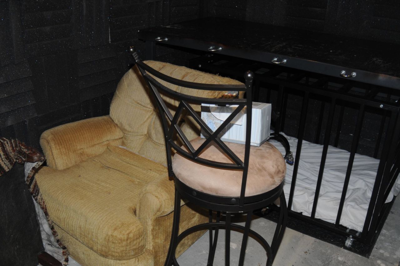 The bed and cage in the dungeon. The cage has a built in feeding hole. 