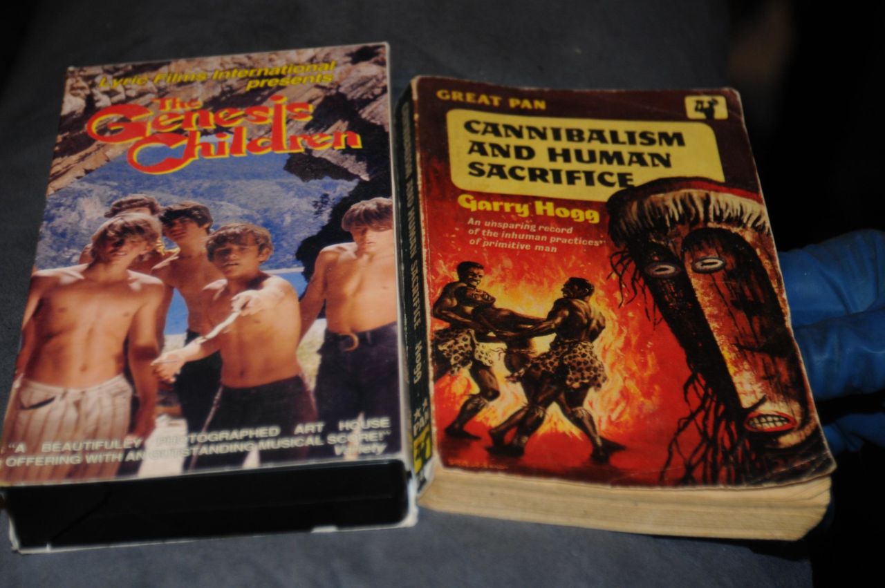 "The Genesis Children" VHS and "Cannibalism and Human Sacrifice" book are more of the disturbing items police found.