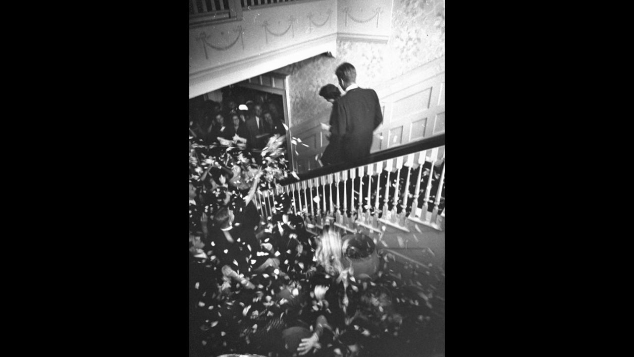Amid a shower of rose-petal confetti and rice, the newlyweds depart the reception to honeymoon in Acapulco, Mexico.