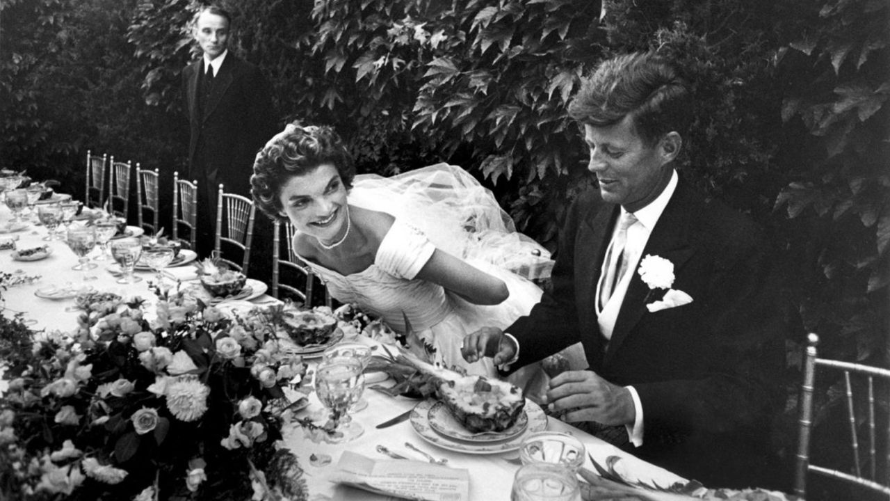 John and Jacqueline Kennedy enjoy lunch during their wedding reception in Newport, Rhode Island, on September 12, 1953. 