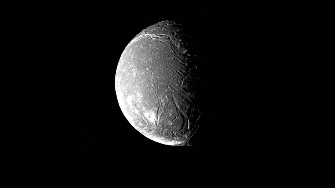 Ariel, another of Uranus' satellite's, shows a densely pitted surface that is also crisscrossed with numerous valleys and fault scarps. 