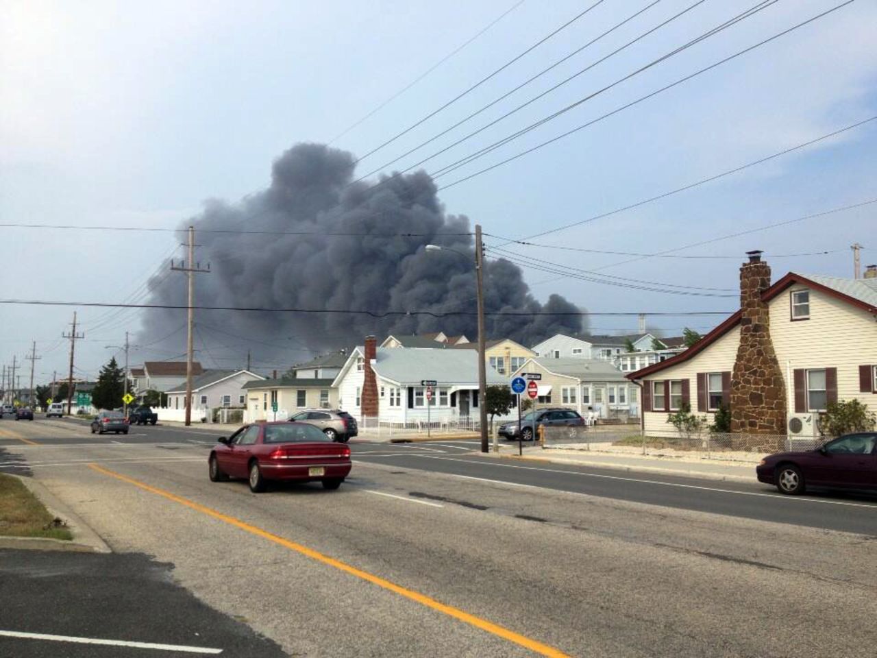 Smoke rises in the distance over homes in the Seaside Heights area.