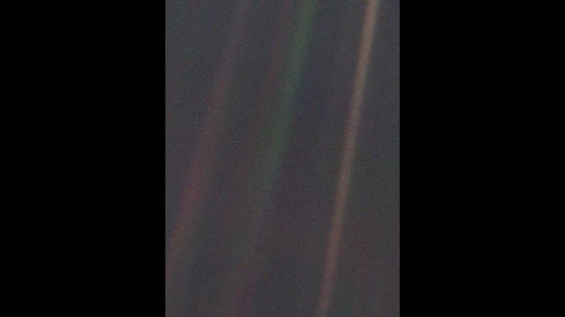 This image of Earth, dubbed "Pale Blue Dot," is a part of the first "portrait" of the solar system taken by Voyager 1. The spacecraft acquired a total of 60 frames for a mosaic of the solar system from a distance of more than 4 billion miles from Earth. Earth lies right in the center of one of the scattered light rays, which are the result of taking the image so close to the sun.