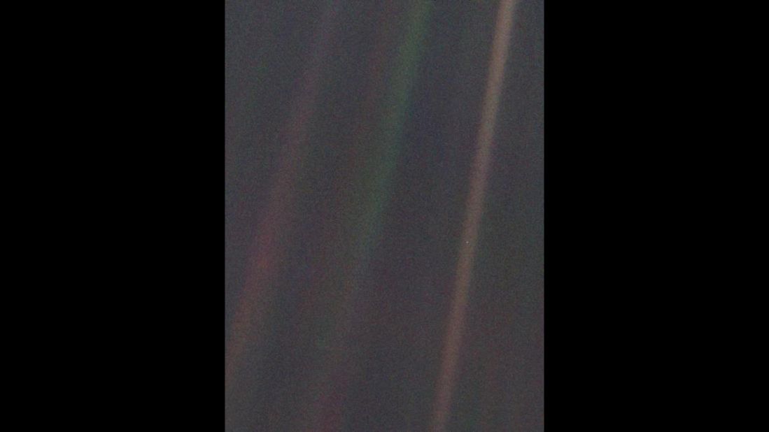 This image of Earth, dubbed "Pale Blue Dot," is a part of the first "portrait" of the solar system taken by Voyager 1. The spacecraft acquired a total of 60 frames for a mosaic of the solar system from a distance of more than 4 billion miles from Earth. Earth lies right in the center of one of the scattered light rays, which are the result of taking the image so close to the sun.