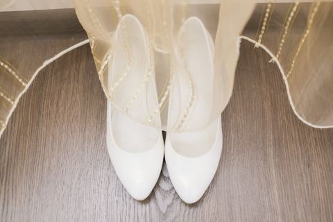 Fancy shoes also might not be worth the splurge. They're often hidden under the dress, and brides slip them off the first second they can.