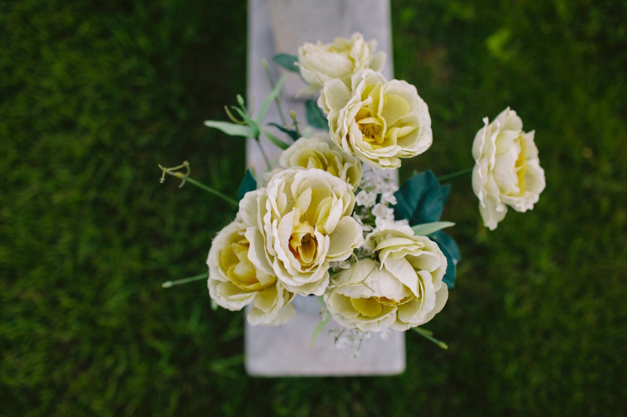 Cloth flowers stand on the headstone of Carol Denise McNair, who went by her middle name. She died at 11, the youngest of the four victims; the other three were 14. Her mother says she was the sort to stand up for others. Etched into the grave marker are the words, "She loved all -- but a mad bomber hated her kind."