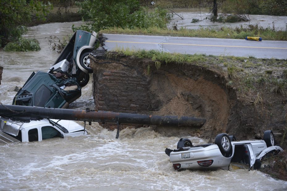 Three vehicles crashed into a creek after the road washed out from beneath them in Broomfield, Colorado, on September 12. Three people were rescued.